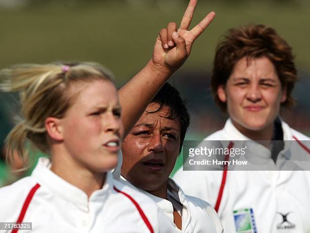 Selena Rudge of England reacts after scoring a try with teammates Charlotte Barras and Shelley Rae against South Africa during the Women's Rugby...