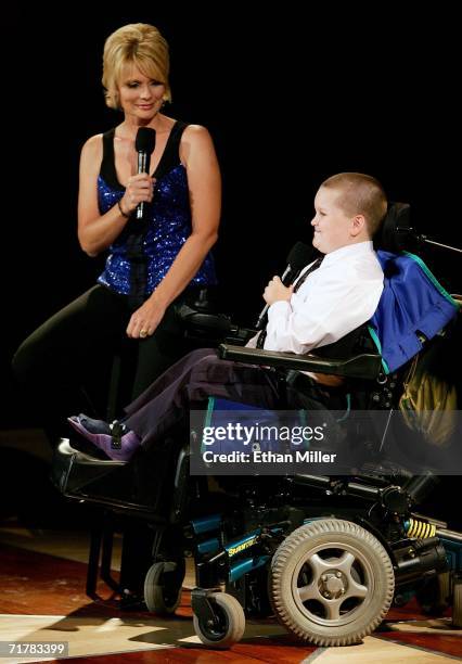 Jerry Lewis Labor Day Muscular Dystrophy Association Telethon co-host Jann Carl talks to MDA 2006 goodwill ambassador Luke Christie during the 41st...