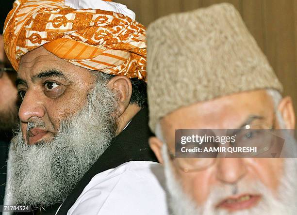 Maulana Fazlur Rehman the leader of the hardline Muttahida Majlis-e-Amal and his party chief Qazi Hussain Ahmad speak during a supreme council...