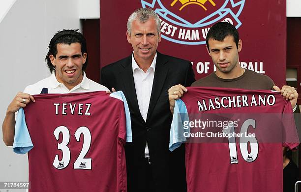Carlos Tevez, West Ham manager Alan Pardew and Javier Mascherano pose with their squad numbers during a West Ham United press conference to unveil...