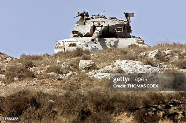 Alma Al-Shaab, LEBANON: An Israeli tank takes position on the top of a hill near the southern Lebanese border village of Alma al-Shaab, 05 September...