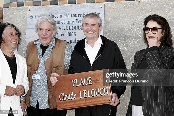 Director Claude Lelouch holds his sign with actress Anouk Aimee , director/composer Pierre Barouh and composer Francis Lai at the 32nd Deauville...