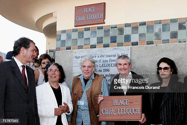 Director Claude Lelouch holds his sign with actress Anouk Aimee , Deauville mayor Philippe Augier, director/composer Pierre Barouh and composer...