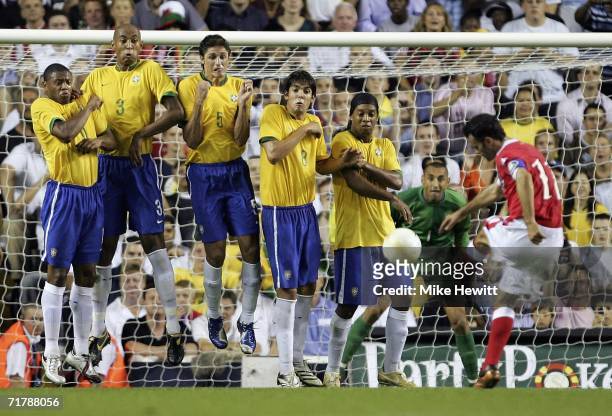 Ryan Giggs of Wales sees his free-kick blocked by the Brazilian wall consisting of Julio Baptista, Anderson Silva, Edmilson, Kaka and Ronaldinho...