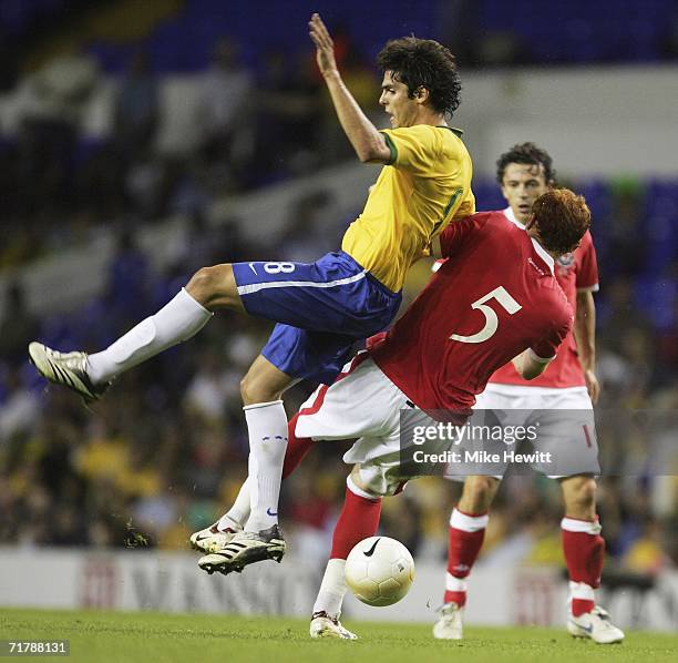 Kaka of Brazil feels the full force of a tackle from James Collins of Wales during the International friendly match between Brazil and Wales at White...