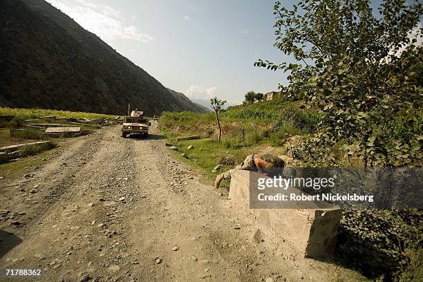 Army soldiers from the 10th Mountain Division move up a dirt road from Naray, Kunar to a Forward Operating Base in Kamdesh, Nuristan August 24 in...