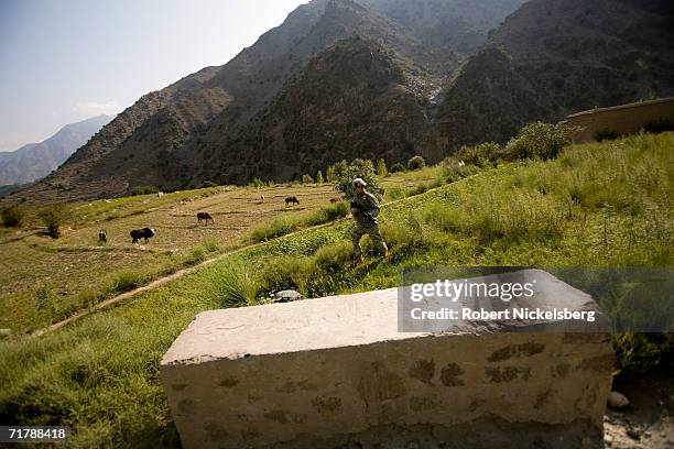 Army soldiers from the 10th Mountain Division move up a dirt road from Naray, Kunar to a Forward Operating Base in Kamdesh, Nuristan August 24 in...