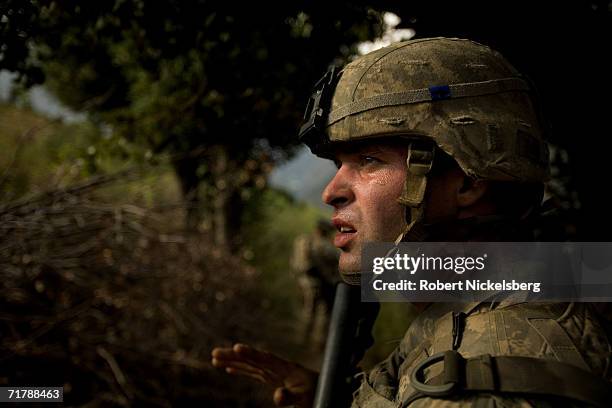 Army soldiers from the 10th Mountain Division walk down a trail from a 7000 foot observation post in Kamdesh, Nuristan August 25 eastern Afghanistan....