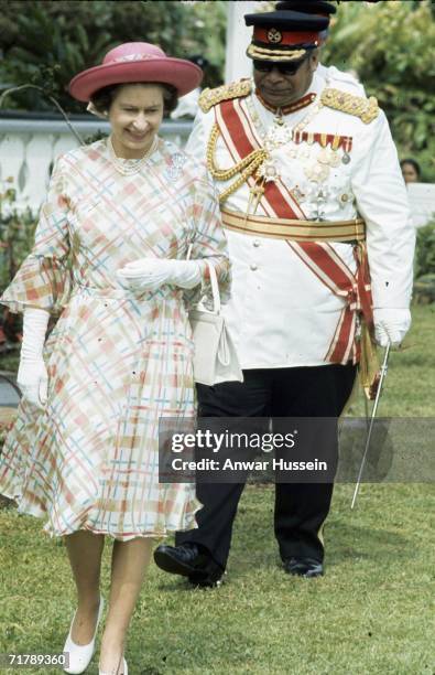 King Taufa'ahau Tupou lV of Tonga walks with Queen Elizabeth ll during her visit with Prince Philip, Duke of Edinburgh to Tonga in February 1977.