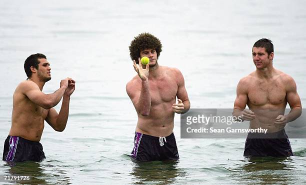 Matt King of the Storm catches a tennis ball watched by team-mates during a Melbourne Storm recovery session at St Kilda Beach on September 6, 2006...