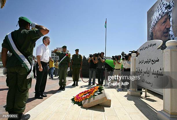 Sinn Fein's Gerry Adams , president of the political wing of the Irish Republican Army , lays a wreath at the grave of the late Palestinian leader...