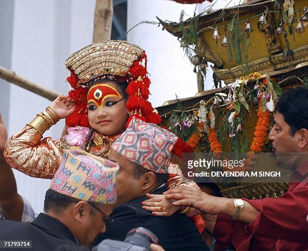 Kumari, a pre-pubescent girl revered by many in Nepal as a living goddess, is taken onto her chariot by Buddhits priests, during the Indra Jatra...