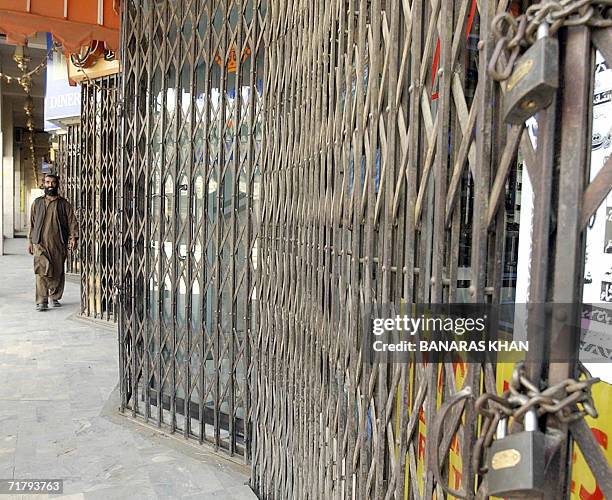 Pakistani man walks past closed shops during a strike in Quetta, 06 September 2006. Parts of the troubled southwest Pakistani province of Baluchistan...
