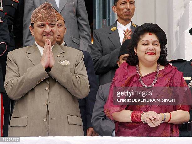 Nepal's King Gyanendra and Queen Komal watch a chariot procession carrying Kumari, a pre-pubescent girl revered by many in Nepal as a living goddess,...