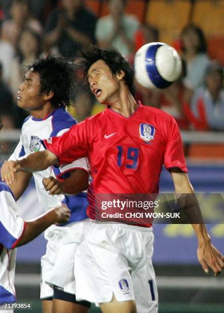 Suwon, REPUBLIC OF KOREA: South Korea's Jung Jo-Gook jumps for the ball with Taiwan's Lin Che-Min during their 2007 Asian Cup qualifying match in...