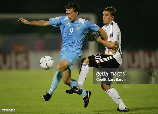 Manuel Marani of San Marino in action with Lukas Podolski of Germany during the UEFA EURO 2008 qualifier between San Marino and Germany at the...