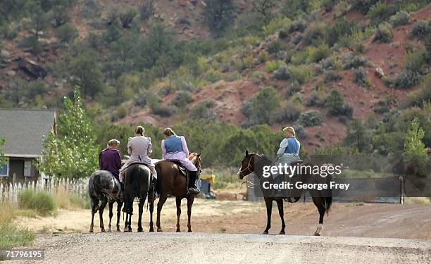 Women sit on horses September 6, 2006 in Colorado City, Arizona. Warren Jeffs, of the Fundamentalist Church of Jesus Christ of Latter Day Saints, is...