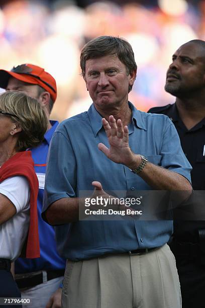 Steve Spurrier, former head coach of the University of Florida Gators, claps as he and other members of the Gators' 1996 National championship team...