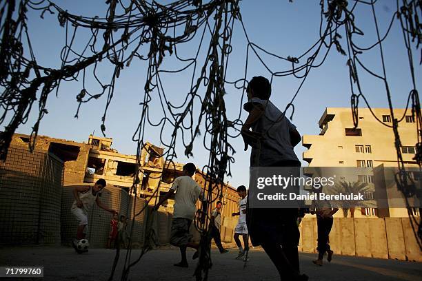 Young Iraqi boys play soccer amongst protective blast walls on September 6, 2006 in Baghdad, Iraq. It was here on October 14, 2005 two suicide...