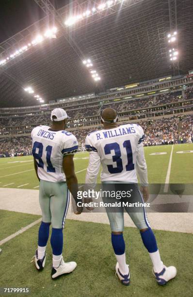 Terrell Owens and Roy Williams of the Dallas Cowboys stand on the sidelines during the preseason game against the Minnesota Vikings on August 31,...