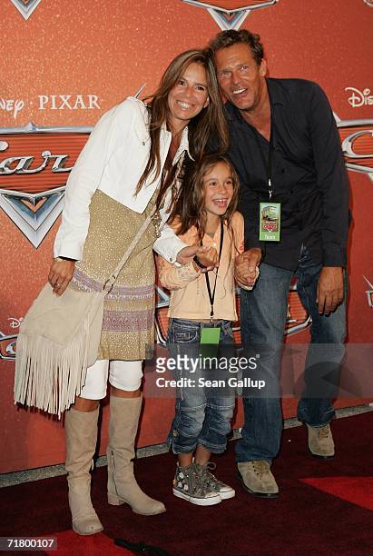 Actor Christian Tramitz, his wife Anette Goebel and daughter Lucia arrive for the German premiere of the animated film "Cars" at a drive-in movie...