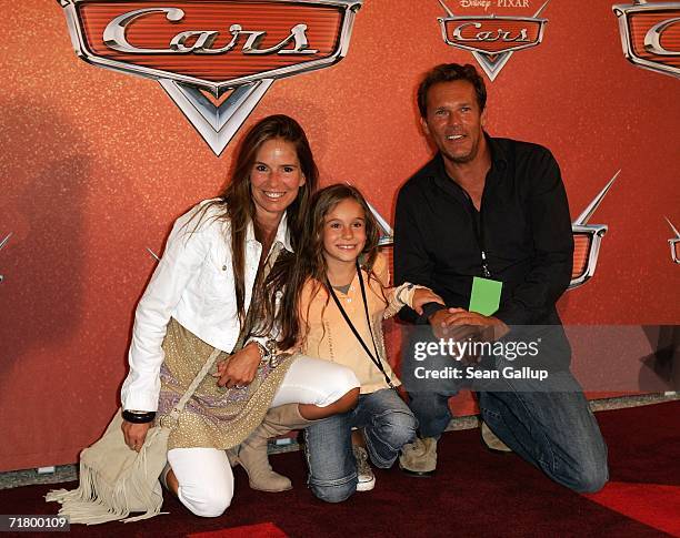 Actor Christian Tramitz, his wife Anette Goebel and daughter Lucia arrive for the German premiere of the animated film "Cars" at a drive-in movie...