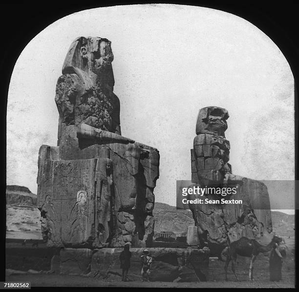 The Colossi of Memnon at Thebes, two giant statues of the Pharaoh Amenhotep III built in the 14th century BC. They originally stood guard over the...