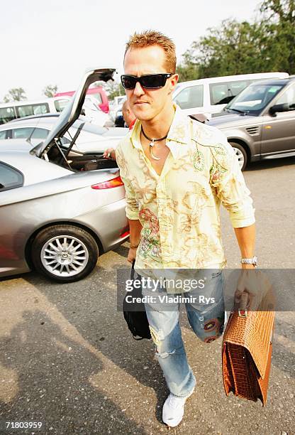 Michael Schumacher of Germany and Ferrari arrives at the paddock during the previews for the Italian Formula One Grand Prix at Autodromo Nazional...