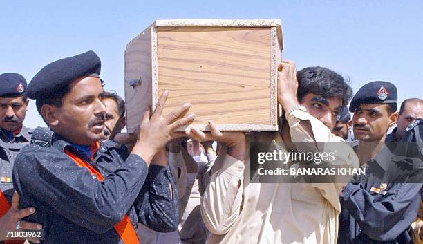 Pakistani policemen carry the coffin of Police officer Khalid Garamkani, during his funeral in Quetta, 07 September 2006. A senior police officer and...