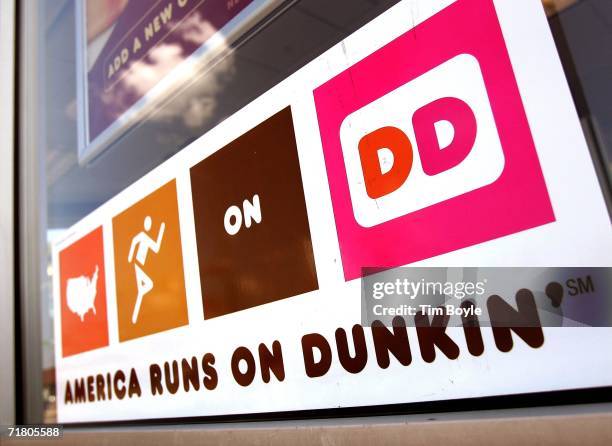 Dunkin' Donuts hangs on a window September 7, 2006 in Chicago, Illinois. In an effort to compete with Starbucks in the lucrative coffee market,...