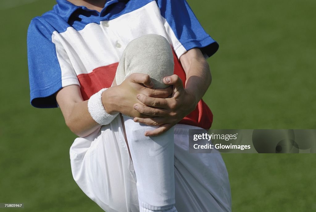 Mid section view of a boy warming up