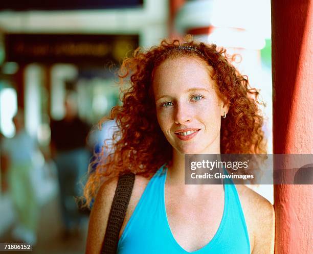 portrait of a young woman leaning against a column, bermuda - bermuda people stock pictures, royalty-free photos & images