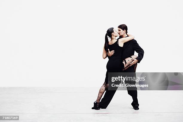 young couple tangoing - tangoing stock pictures, royalty-free photos & images