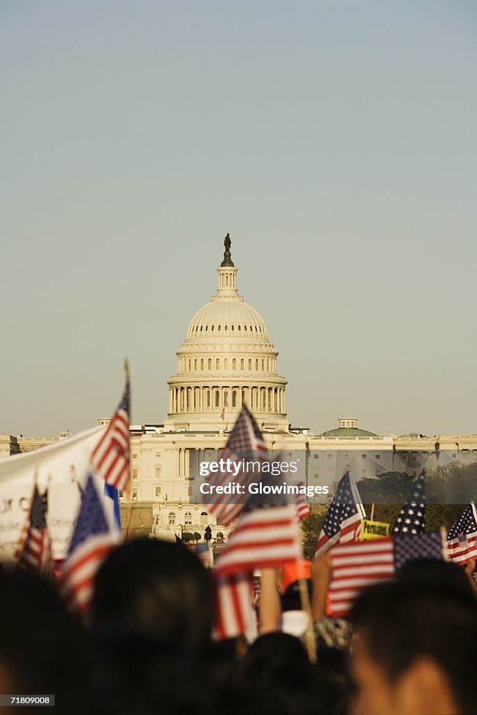 Crowd holding the American flags in front of a government building, California State Capitol Building, California, USA