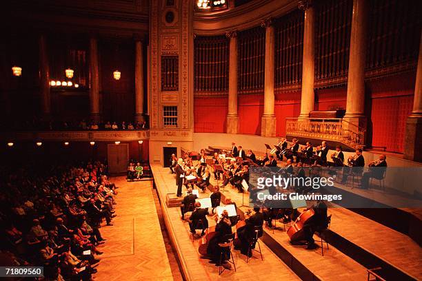 high angle view of musicians playing at a concert, hofburg concert orchestra, hofburg palace, vienna, austria - orchestra sinfonica foto e immagini stock