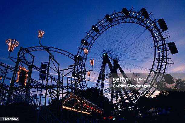 silhouette of amusement park rides, prater park, vienna, austria - プラーター公園 ストックフォトと画像