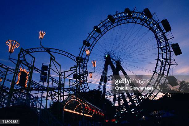 silhouette of amusement park rides, prater park, vienna, austria - luna park stock pictures, royalty-free photos & images