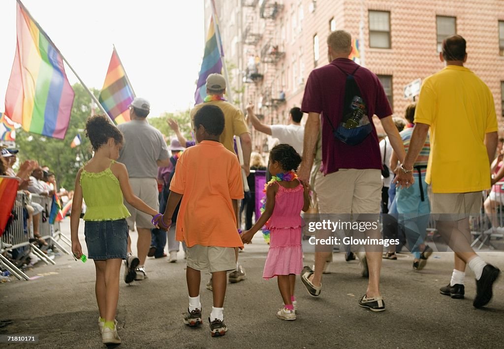 Rear view of a group of people walking at a gay parade