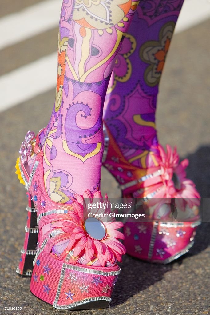 Close-up of a person's painted legs in high heels