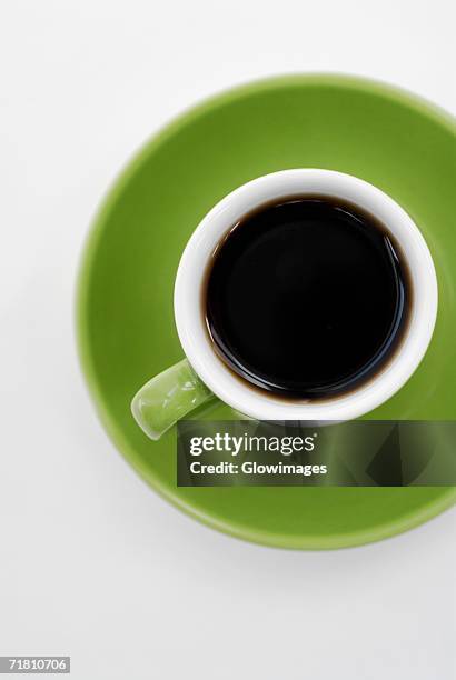 high angle view of a cup of black tea on a saucer - tea cup overhead view photos et images de collection