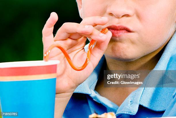 close-up of a boy drinking with a straw - straw lips stock pictures, royalty-free photos & images