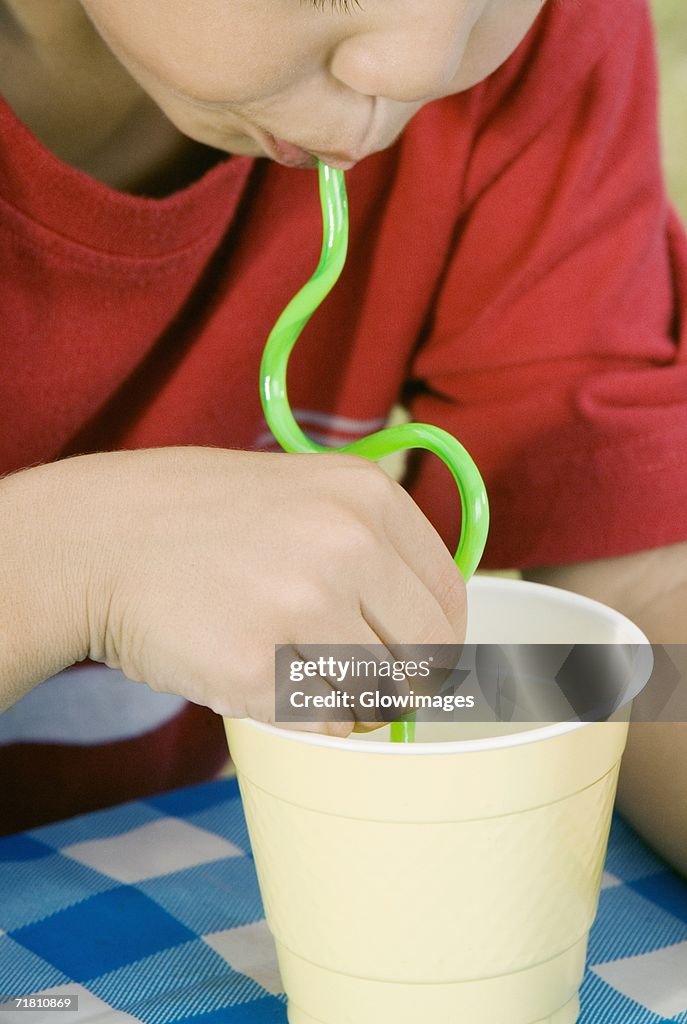 Close-up of a boy drinking with a straw