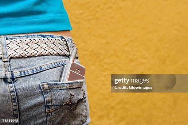 close-up of a mobile phone in a teenage girl's back pocket - phone in back pocket stock pictures, royalty-free photos & images