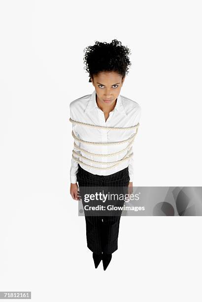 high angle view of a businesswoman tied up with rope - bound in high heels stock pictures, royalty-free photos & images