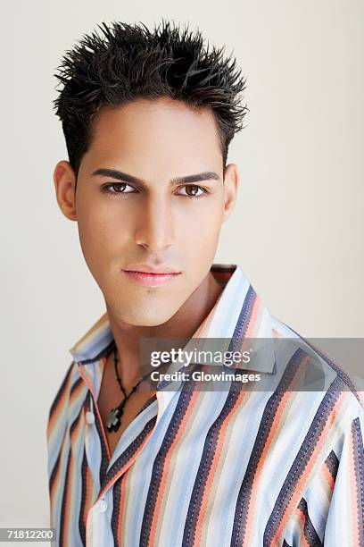 portrait of a man looking serious - cross stripes shirt stockfoto's en -beelden