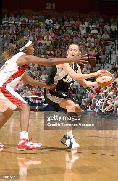 Agnieszka Bibrzycka of the San Antonio Silver Stars battles to pass the ball against Asjha Jones of the Connecticut Sun during the game at Madison...