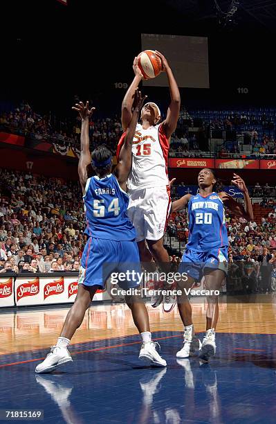 Asjha Jones of the Connecticut Sun reaches for the basket under pressure from Barbara Farris of the New York Liberty during the game at Madison...