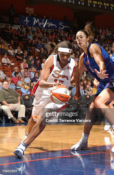 Asjha Jones of the Connecticut Sun drives past Ruth Riley of the Detroit Shock during a pre-season game at Mohegan Sun Arena on May 7, 2006 in...