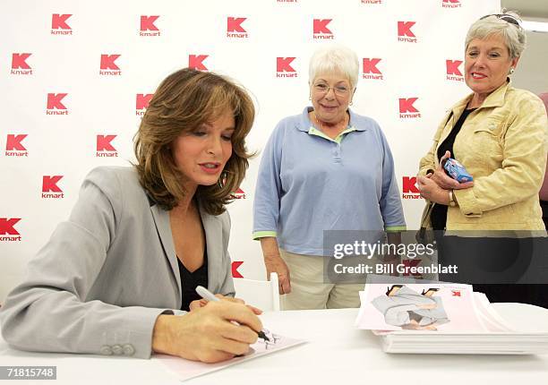 Actress and designer Jaclyn Smith signs a photograph for fans during an appearance at a K-Mart Store in St. Louis on September 7, 2006. Smith, who...