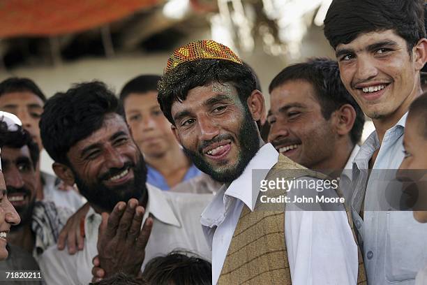 Afghan refugee and groom Mohammed Pervez is congratulated by family after his wedding on September 8, 2006 at the Khazana refugee camp on the...